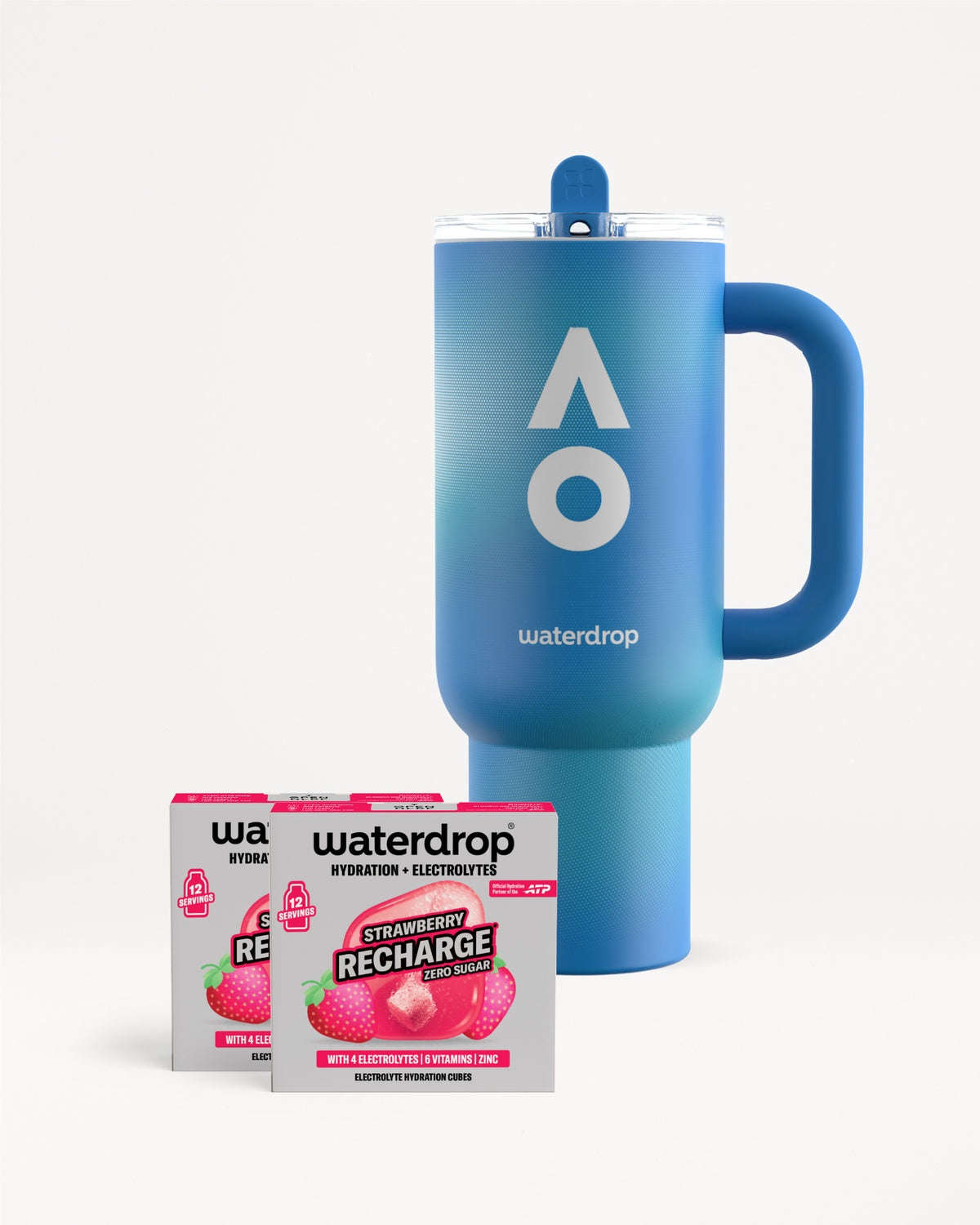 Kék waterdrop termoszbögre fogantyúval és tetővel, mellette két Strawberry Recharge cukormentes doboz, dobozonként 12 adaggal, fehér háttéren.