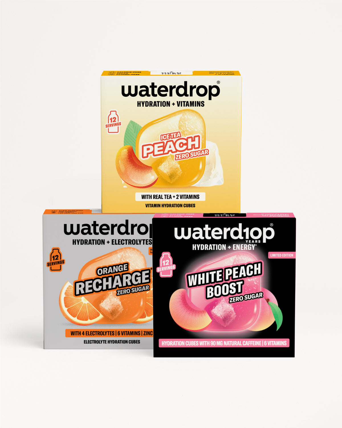 Három Waterdrop hidratáló ital és vitamin doboz, íz: barack, narancs Recharge és White Peach Boost, fehér háttéren egymásra helyezve.